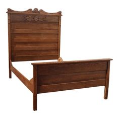 a wooden bed frame with an intricate headboard and foot board, made in the usa