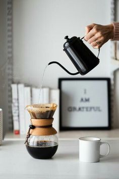 a person pours coffee into a cup