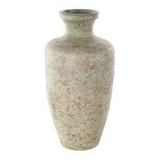 a white vase with speckles on the outside and inside, sitting in front of a white background