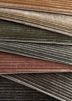 many different colored carpet samples are stacked on top of each other in this close up photo