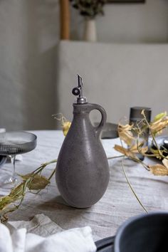 a gray vase sitting on top of a table