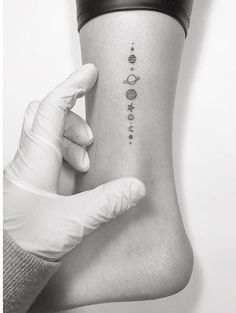 a woman's arm with the planets on it