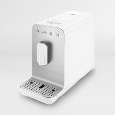 a white coffee machine sitting on top of a counter