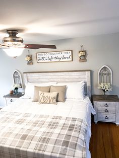 a bedroom with a bed, nightstands and ceiling fan in the middle of it