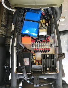 the engine compartment of a vehicle with many different types of wires and other things in it