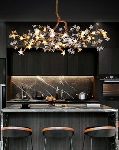 a modern kitchen with an island and bar stools