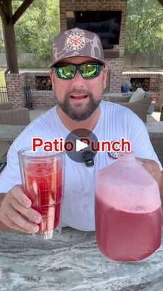 a man sitting at a table with two drinks in front of him