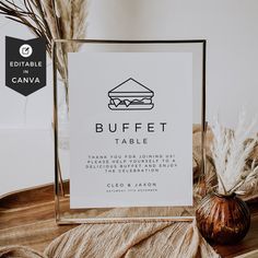 a sign that says buffet table on it next to a vase with dried grass in it