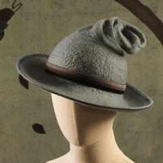 This breton brimmed, curly topped Witch's hat is hand felted in verdigris (dusty grayish green) Merino wool. The brim is bound in green dupioni silk while the crown is encircled with a velvet ribbon. The brim is approximately 14 to 12 inches across. Bear in mind that these are hand felted, so each one will be unique. Your hat will not look exactly like the one pictured but will be equally fabulous. You can request some specifics such as approximate curlicue length and brim width. How to measure Vintage Felt Hat With Flat Brim, Vintage Gray Brimmed Hat, Vintage Felt Hats For Fall, Vintage Wide Brim Felt Hat, Vintage Gray Hat, Felt Witch Hat, 1940's Style, Grayish Green, Boho Hat