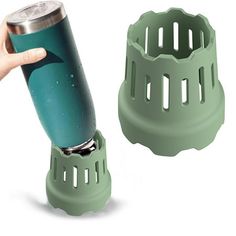 a hand holding a green cup holder next to an empty can with a shark on it