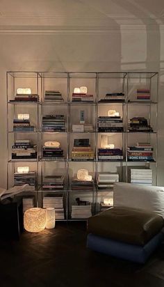 a living room filled with lots of books and furniture