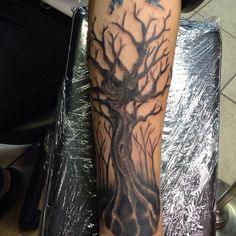 a person with a tree tattoo on their arm