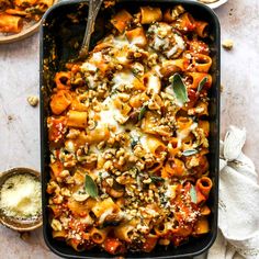 a casserole dish filled with pasta and vegetables