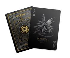 two playing cards, one black and the other gold with an image of a dragon on it