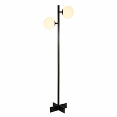 a black floor lamp with two white balls on it