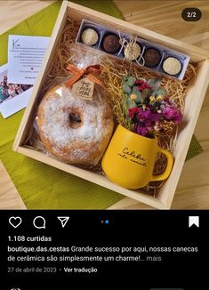 an open box containing a donut and coffee