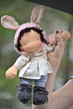 a doll is being held by a woman