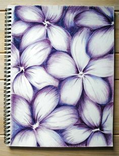 a spiral notebook with purple and white flowers on it