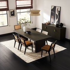 a dining room table and bench in front of two windows