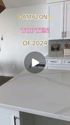 the kitchen counter top is white and has an amazon logo over it that says,'top ten of 2014 '