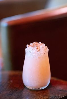 a drink sitting on top of a wooden table