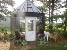 a small gazebo with chairs around it