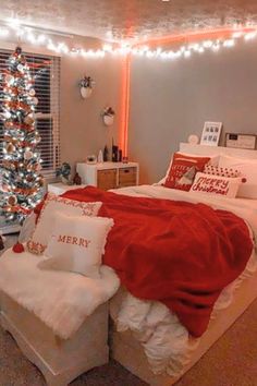 a bedroom decorated for christmas with lights on the ceiling and a tree in the corner