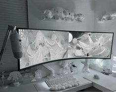 a computer desk topped with two monitors next to a white keyboard and mouse on top of it