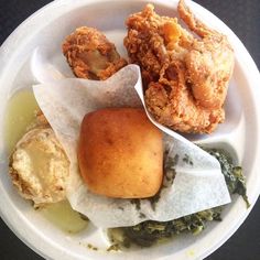 a white plate topped with different types of food on top of a black tablecloth