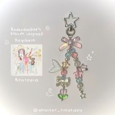 a keychain with charms attached to it on a white background and an image of a fairy