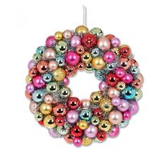 a christmas ornament hanging on a white wall with ornaments in the shape of a wreath