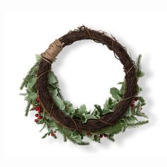 a wreath with holly and red berries hanging from it's sides on a white background