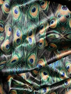 peacock feathers are spread out on a black background with blue, green and yellow colors