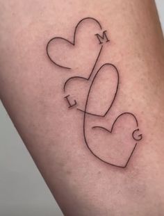 a couple of hearts that are connected to each other on the thigh, with an arrow in the middle