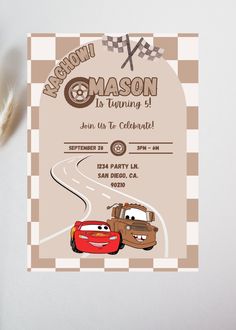 a birthday party with cars on the road and an envelope for someone's first birthday