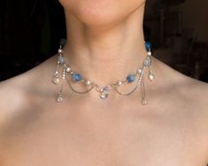 This handmade beaded Blue Fairy Necklace is made with glass, acrylic, and resin beads, with stainless steel chains.  ✧ Size: 12 inches with a 2-inch extender (adjustable to 14 inches). Perfect for those with a petite neck. If you need a larger or smaller size, message me with your desired measurements! I can add more beads and/or a second extender.  ✧ Closure: Lobster claw ✧ Care: For longevity, please keep away from water and perfumes. If you have any questions, feel free to reach out ♡ For more, visit my shop: https://www.etsy.com/shop/stardropstop Fairy Beaded Necklace, Necklace Reference, Coquette Necklace, Necklace Fairycore, Cottagecore Jewelry, Reference Ideas, Necklace Inspiration, Diy Necklaces, Beaded Necklace Patterns