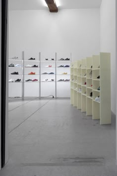 the inside of a shoe store with rows of shoes on shelving units and shelves