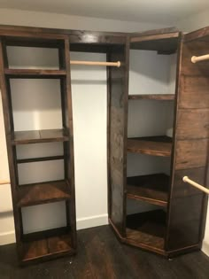 an empty closet with two open shelves on each side and one closed shelf in the middle