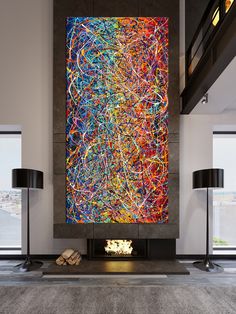 a large abstract painting on the wall in a living room with two lamps and a fireplace