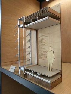 a display case with a drawing of a man in it on the wall next to shelves