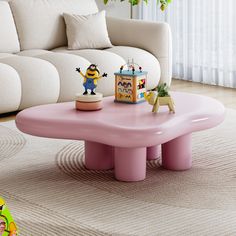 a pink coffee table with figurines on it in front of a white couch