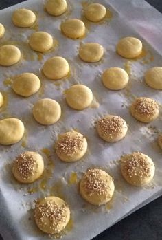 the cookies are ready to be baked on the baking sheet and then covered with sesame seeds