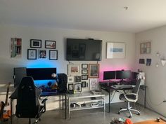 a room with multiple computer monitors and pictures on the wall