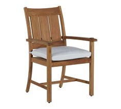 a wooden chair with a white cushion on it's armrest and seat pad