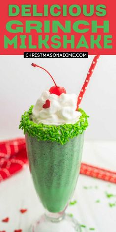 a green drink with whipped cream and cherries in it, on top of a white table