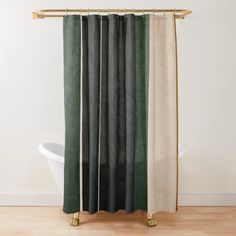 a shower curtain with green, beige and black colors on it in a bathroom setting