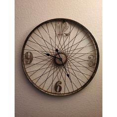 a clock that is on the wall with numbers and spokes attached to it's face