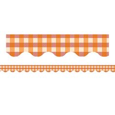 an orange and white checkered table cloth with scalloped edges on a white background