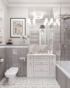 a bathroom with gray and white tile flooring, a sink, toilet and tub