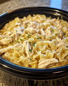 a close up of a plate of food on a table with a bowl of pasta